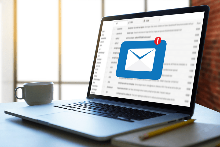 Aufgeklappter Laptop. Auf dem Screen ein übergelagertes Briefsymbol